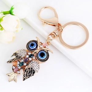 Creative owl keychain with evil eye details and colorful rhinestones on gold alloy base