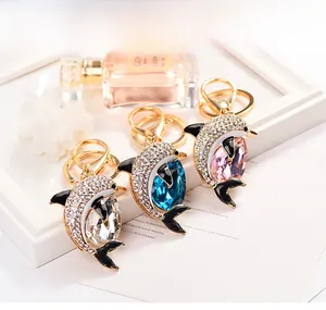 Detailed macro of luxury dolphin keychains with sparkling crystals in three colors