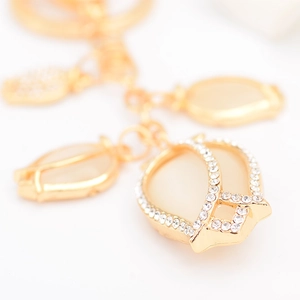 Golden tulip keychain with cat-eye stone and crystal rhinestones on white background