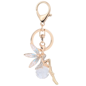 Exquisite golden angel keychain with enamel wings and crystal ball on white background