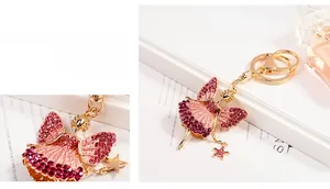 Detailed close-up of a sparkling pink rhinestone ballet girl keychain with golden finish