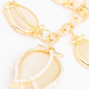 Elegant gold tulip pendant keychain with opal-like finish and sparkling rhinestones