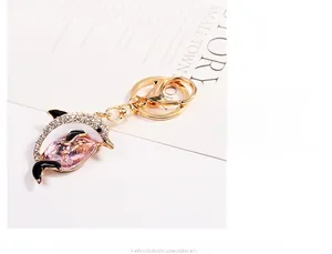 Macro detail of dolphin keychain featuring pink crystal and sparkling diamond inlay