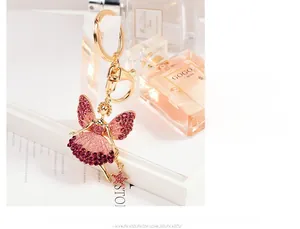 Detailed close-up of a golden angel keychain with purple rhinestones and a star charm