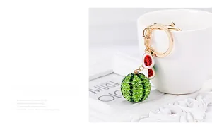 Detailed view of watermelon keychain with sparkling green rhinestones on white cup