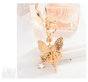 Detailed macro view of golden ballerina angel pendant with shiny star charm and D-ring