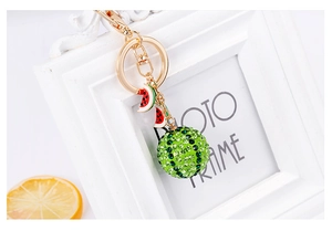 Close-up of rhinestone watermelon keychain with green crystals and enamel slices