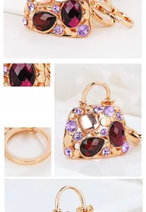 Detailed close-up of a handbag-shaped keychain with purple and red crystals and gold plating
