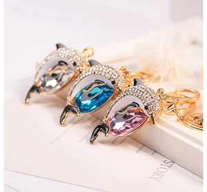 Detail of dolphin keychains with sparkling crystals and pavé rhinestones in three colors