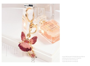 Exquisite ballet dancer keychain with sparkling pink rhinestones and a star pendant detail