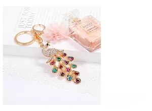 Detail of crystal peacock keychain with colorful rhinestones on a decorative background