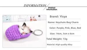 Detail view of a sleeping plush kitten inside a purple knitted shoe keychain charm