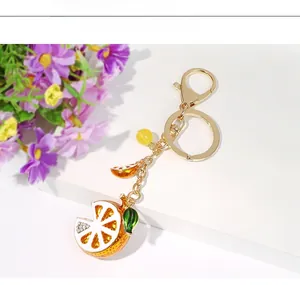 Detailed macro of a crystal lemon slice keychain with enamel glaze and lobster clasp