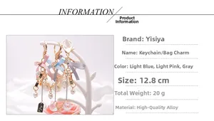 Detail view of bow keychain with pearls and stars showing dimensions of 12.8cm
