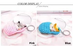 Detailed view of pink and blue sleeping cat keychains with soft plush and knit textures