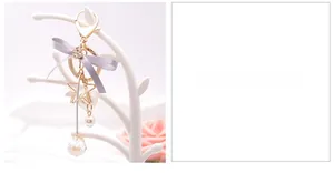 Detail view of grey silk bow keychain with star-shaped pearl frame and crystal drop