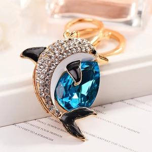 Luxury dolphin keychain with blue pear-shaped gemstone and crystal inlay on gold base