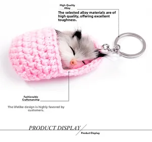 Detail of high-quality alloy metal clip on sleeping cat keychain with pink knit base