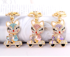 Set di tre portachiavi a forma di volpe su scooter con strass blu, rosa e viola scintillanti