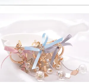 Detailed view of bowknot star pendants with pearls and crystal balls in three colors