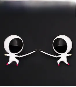 Detail of two creative cartoon fencers keychain charms with silver foils on black background