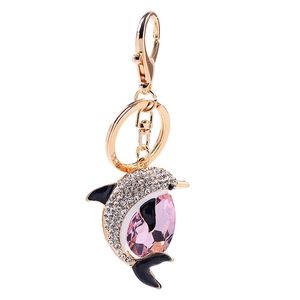 Luxury gold dolphin keychain with sparkling white rhinestones and a large pink crystal