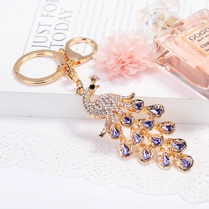 Sparkling crystal peacock keychain with purple rhinestones on a gold alloy metal ring