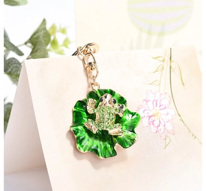 Close-up of green frog and lotus leaf keychain with sparkling green rhinestones