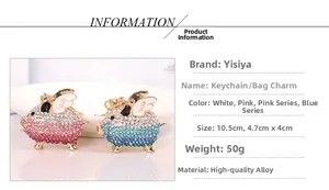 Detail of flying pig keychains with sparkling rhinestones and white enamel wings