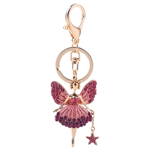 Golden fairy keychain with pink and purple rhinestones on a clean white background