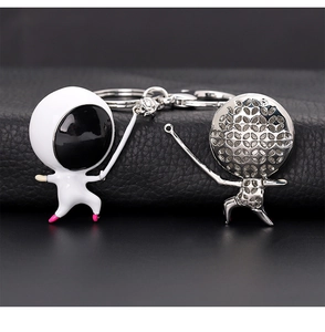 Close-up of creative fencing athlete keychains in white enamel and polished silver finish