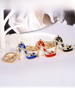Detailed close-up of high heel shoe keychains in blue, red, and black with rhinestones