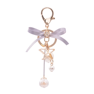 Pastel purple bow keychain with gold star frame, pearls and clear crystal pendant