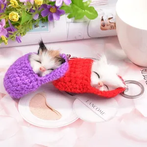 Cute sleeping plush cat keychain set in purple and red with knit bags and fur pompom