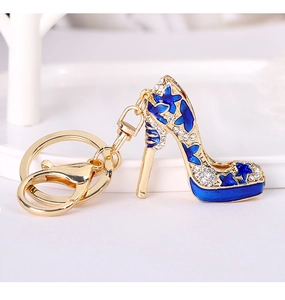 Detail of high heel keychain featuring royal blue butterfly design and sparkling crystals