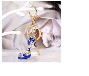 Detail of high heel keychain with blue enamel stars and crystals on a golden frame