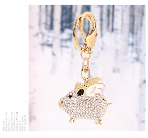 Macro view of flying pig alloy keychain with sparkling white rhinestones and lobster clasp