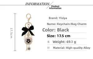 Detailed view of alloy keychain with black bow, pearl beads and Eiffel Tower charm