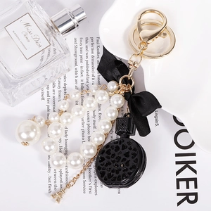 Detail of pearl keychain with black ribbon bow and gold Eiffel Tower charm
