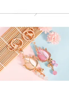 Detailed macro view of opal tulip charms with gold plating and sparkling crystals