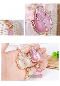 Macro view of gold tulip pendant with opal-style stones and shimmering rhinestones