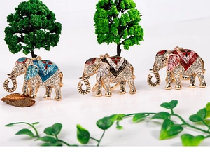 Macro detail of elephant keychains with sparkling crystals and colorful enamel patterns