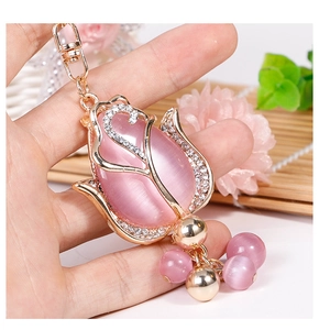 Detailed macro view of pink opal tulip keychain with gold plating and sparkling crystals