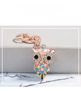 Dettaglio del portachiavi a gufo in oro rosa con pietre occhio di gatto e strass