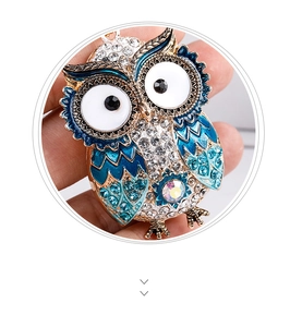 Detail of owl keychain with blue enamel feathers and sparkling rhinestone crystal inlay