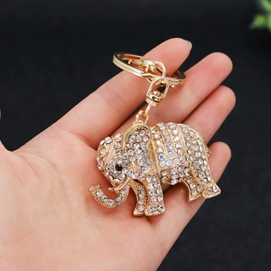 Gold elephant keychain with sparkling rhinestones held by hand as a bag charm
