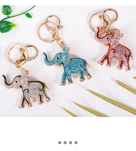Detailed view of rhinestone elephant keychains in blue, pink, and white crystal finishes