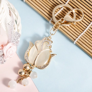 Elegant gold tulip keychain featuring opal stone and sparkling rhinestone accents