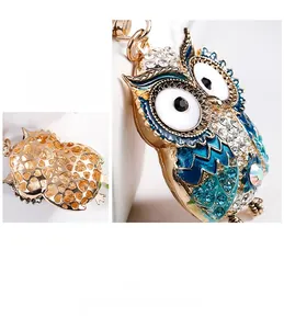 Detailed macro view of the rhinestone owl keychain with intricate hollowed heart back pattern