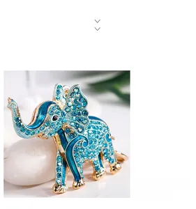 Macro shot of gold elephant keychain with blue rhinestones and enamel craft